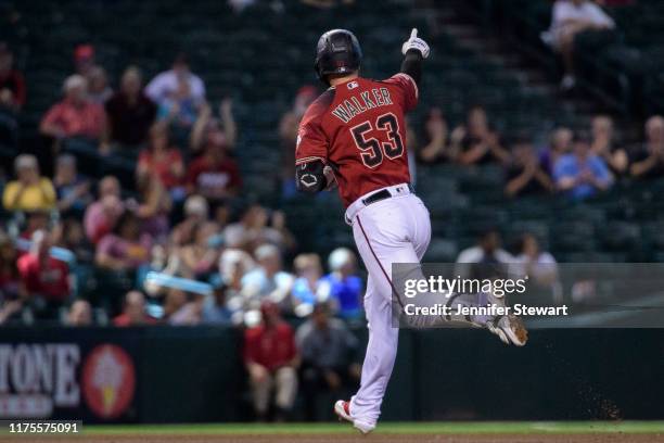 Christian Walker of the Arizona Diamondbacks points to the bullpen after hitting a solo home run in the fifth inning of the MLB game against the...