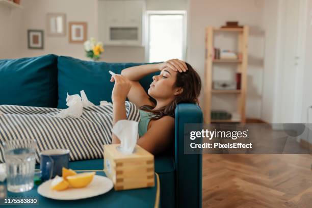 woman in checking temperature - caucasian woman sick in bed coughing stock pictures, royalty-free photos & images