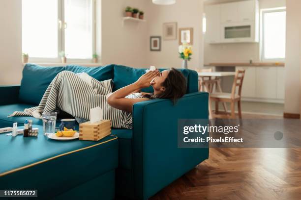 the sneezes just keep on coming - caucasian woman sick in bed coughing stock pictures, royalty-free photos & images