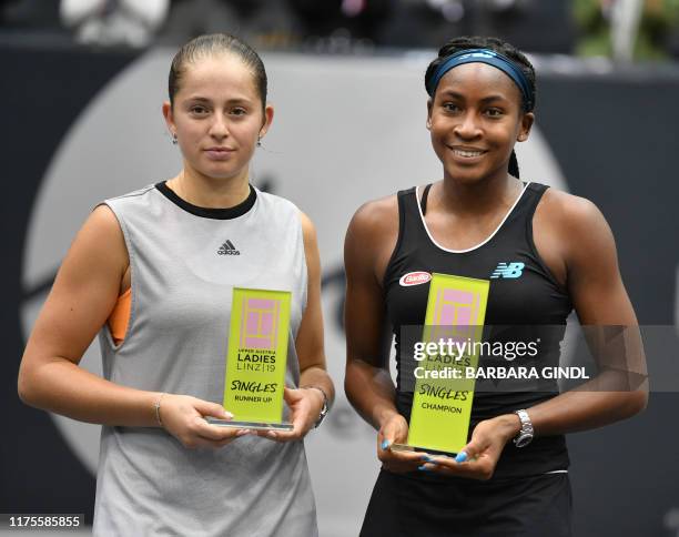 Runner up Jelena Ostapenko of Latvia and winner Cori Gauff of US pose with a trophy after their WTA-Upper Austria Ladies final tennis match on...