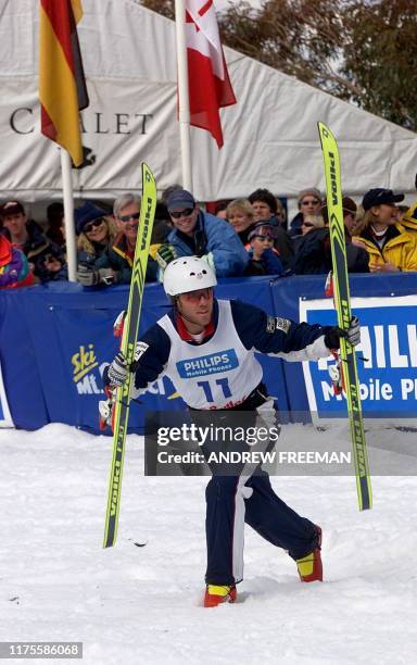 Current Olympic champion Eric Bergoust from the US makes his way across the snow without his skies after winning the second Philips Mobile Phones...