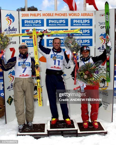 Ales Valenta from Czech Republic who came second, and Andy Capicik from Canada who came third stand along side Eric Bergoust from the US at the medal...