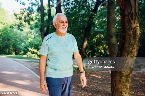 senior man finishing his running training - endurance walking stock pictures, royalty-free photos & images