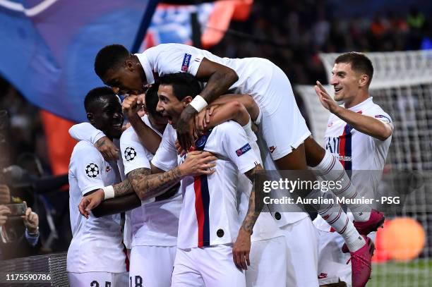 Angel Di Maria of Paris Saint-Germain is congratulated by teammates after scoring during the UEFA Champions League group A match between Paris...