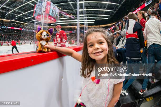 Fan poses with soft toy during the Swiss National League game between Lausanne HC and HC Lugano at Vaudoise Arena on October 13, 2019 in Lausanne,...