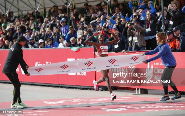 Kenya's Brigid Kosgei crosses the finish line as she wins the women's 2019 Bank of America Chicago Marathon with the World Record on October 13 2019...