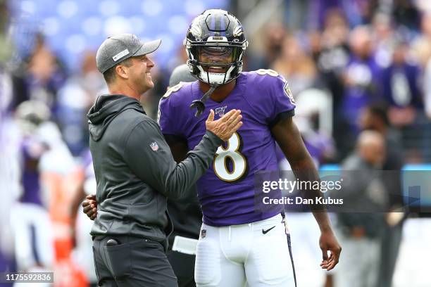 Head coach John Harbaugh interacts with Lamar Jackson of the Baltimore Ravens prior to playing against the Cincinnati Bengals at M&T Bank Stadium on...