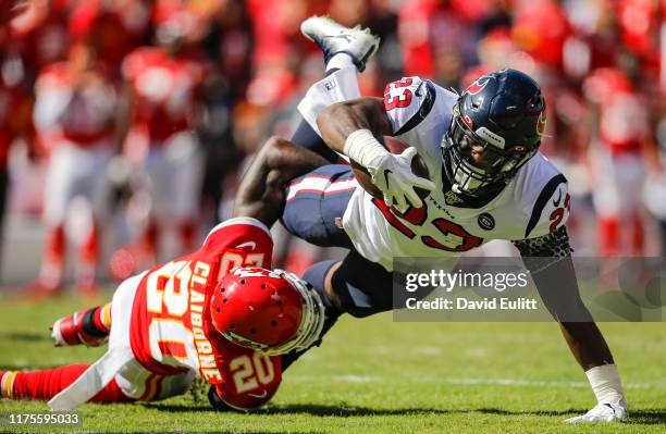 Morris Claiborne of the Kansas City Chiefs tackles Carlos Hyde of the Houston Texans in the second quarter at Arrowhead Stadium on October 13, 2019...