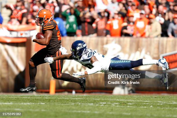 Nick Chubb of the Cleveland Browns slips past an attempted tackle by Bradley McDougald of the Seattle Seahawks during the first quarter at...