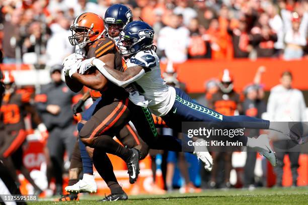 Shaquill Griffin of the Seattle Seahawks and Tre Flowers combine to tackle Nick Chubb of the Cleveland Browns during the first quarter at FirstEnergy...