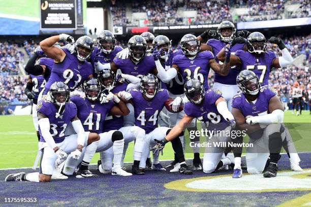 Marlon Humphrey of the Baltimore Ravens celebrates with teammates after making an interception against the Cincinnati Bengals during the first half...