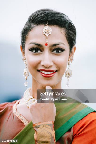 indian woman dancing in traditional clothing downtown city setting - bindi stock pictures, royalty-free photos & images