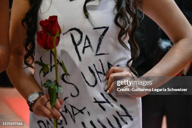 Detail of a model's dress created by former FARC rebels after walking the runway during the fashion show "Pazarela" as part of the Dia Paiz...