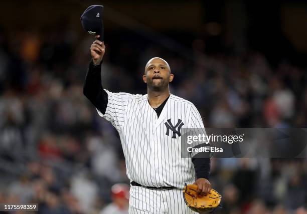 Sabathia of the New York Yankees salutes the fans as he is pulled from the game in the third inning against the Los Angeles Angels at Yankee Stadium...