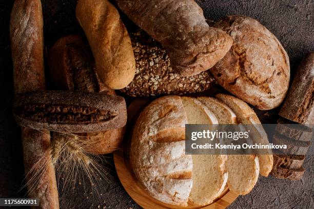 freshly baked traditional bread on wooden table - loaf of bread stock-fotos und bilder