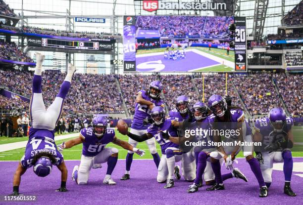 Mackensie Alexander of the Minnesota Vikings celebrates with teammates after intercepting the ball in the fourth quarter of the game against the...