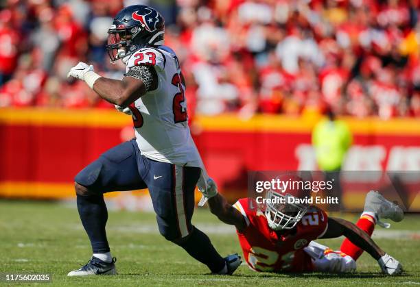 Bashaud Breeland of the Kansas City Chiefs holds on to the jersey of Carlos Hyde of the Houston Texans in the fourth quarter at Arrowhead Stadium on...