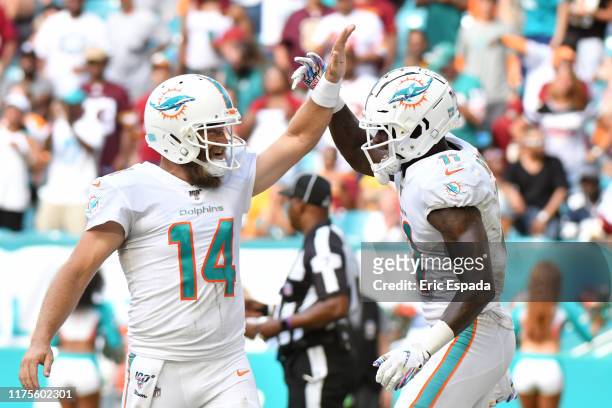 DeVante Parker of the Miami Dolphins celebrates with Ryan Fitzpatrick after scoring a touchdown in the fourth quarter against the Washington Redskins...