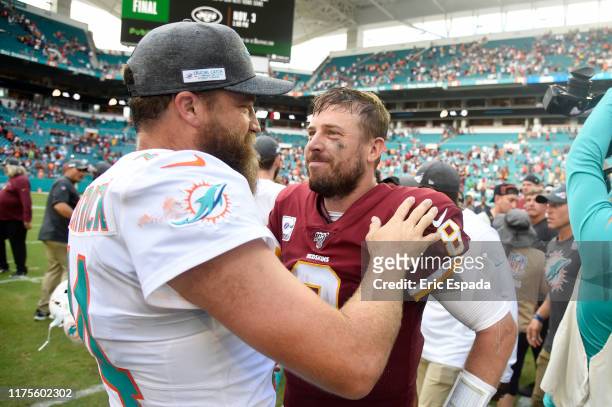 Ryan Fitzpatrick of the Miami Dolphins congratulates Case Keenum of the Washington Redskins after the game at Hard Rock Stadium on October 13, 2019...