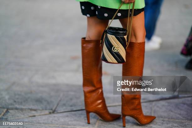 Gucci striped bag is seen, outside the Alberta Ferretti show during Milan Fashion Week Spring/Summer 2020 on September 18, 2019 in Milan, Italy.
