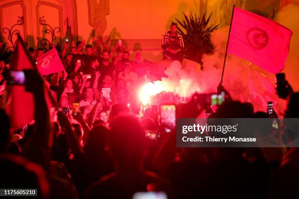 Supporters of Tunisian presidential candidate Kais Saied celebrate in the street after the first exit poll in presidential runoff vote suggest he is...