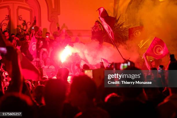 Supporters of Tunisian presidential candidate Kais Saied celebrate in the street after the first exit poll in presidential runoff vote suggest he is...