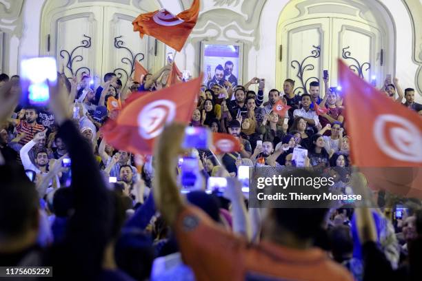 Supporters of Tunisian presidential candidate Kais Saied celebrate in the street after the first exit poll in presidential runoff vote suggest he is...