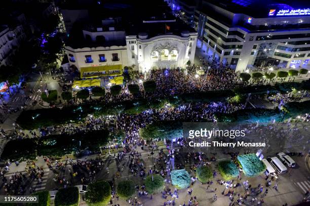 Supporters of Tunisian presidential candidate Kais Saied celebrate in the street after the first exit poll in presidential runoff vote suggest he is...