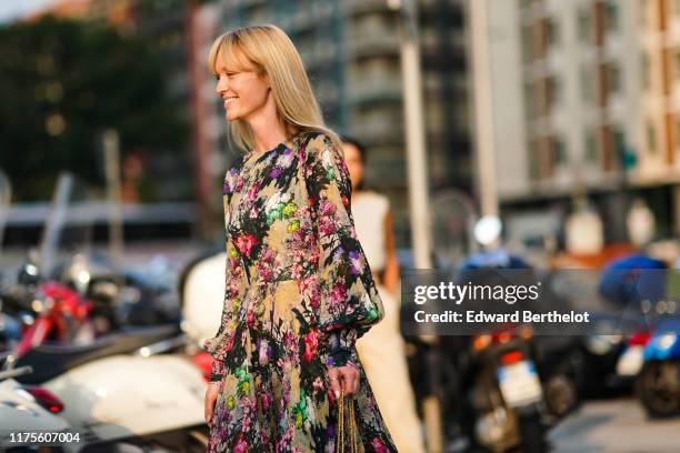 Jeanette Madsen wears a colored floral print dress, outside the Alberta Ferretti show during Milan Fashion Week Spring/Summer 2020 on September 18,...