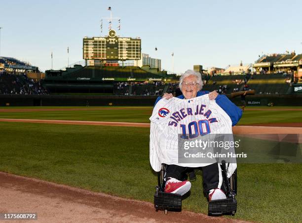 Dolores Schmidt "Sister Jean" of the Loyola Ramblers men's basketball team poses with a Cubs jersey given to her by manager Joe Maddon before the...