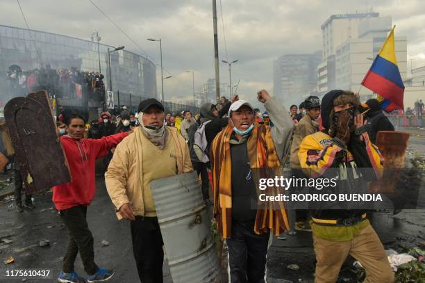 Demonstrators protest against a fuel price hike ordered by the government to secure an IMF loan in Quito on October 13, 2019. - A first meeting...