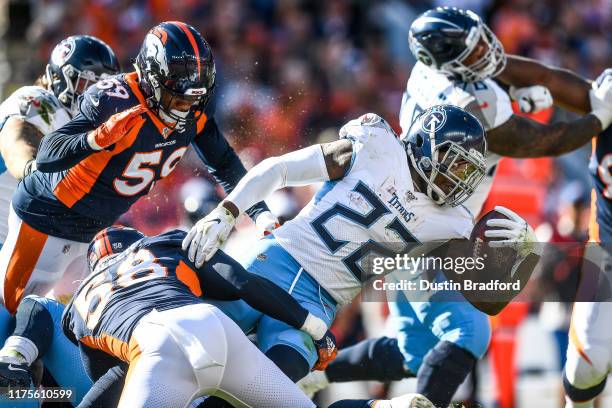 Derrick Henry of the Tennessee Titans is tackled by Von Miller of the Denver Broncos in the second quarter at Empower Field at Mile High on October...