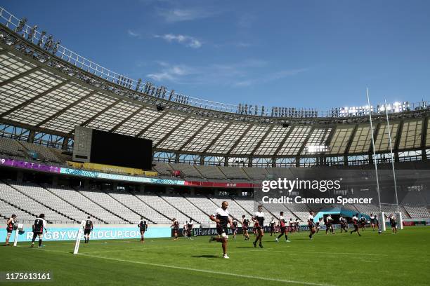 Japan captain Michael Leitch and team mates warm up during the Japan Captain's Run at the Tokyo Stadium on September 19, 2019 in Chofu, Tokyo, Japan.