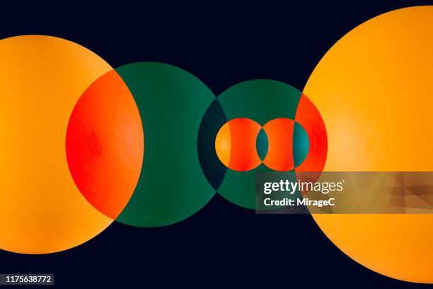green and orange circle overlapping - continuous loop stock pictures, royalty-free photos & images