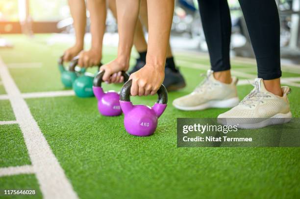 group of sport girl and sport man having functional fitness training with kettlebell in sport gym. - exercise machine stock pictures, royalty-free photos & images