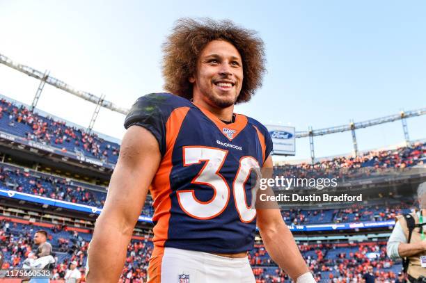 Phillip Lindsay of the Denver Broncos smiles as he walks on the field after the Denver Broncos 16-0 win over the Tennessee Titans at Empower Field at...