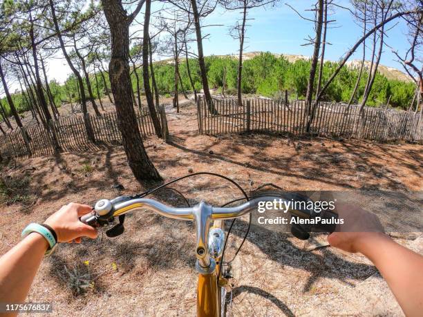 handle bar on a bicycle seen from the point of view of the cyclist with ocean sand dunes in background - bike handle stock pictures, royalty-free photos & images