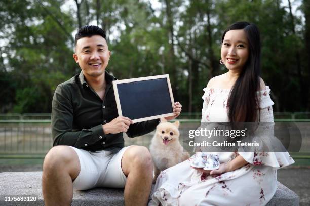 married couple holding a sign board - couple placard stock pictures, royalty-free photos & images