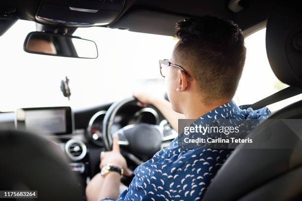 wealthy asian man driving a car - uber driver stock pictures, royalty-free photos & images