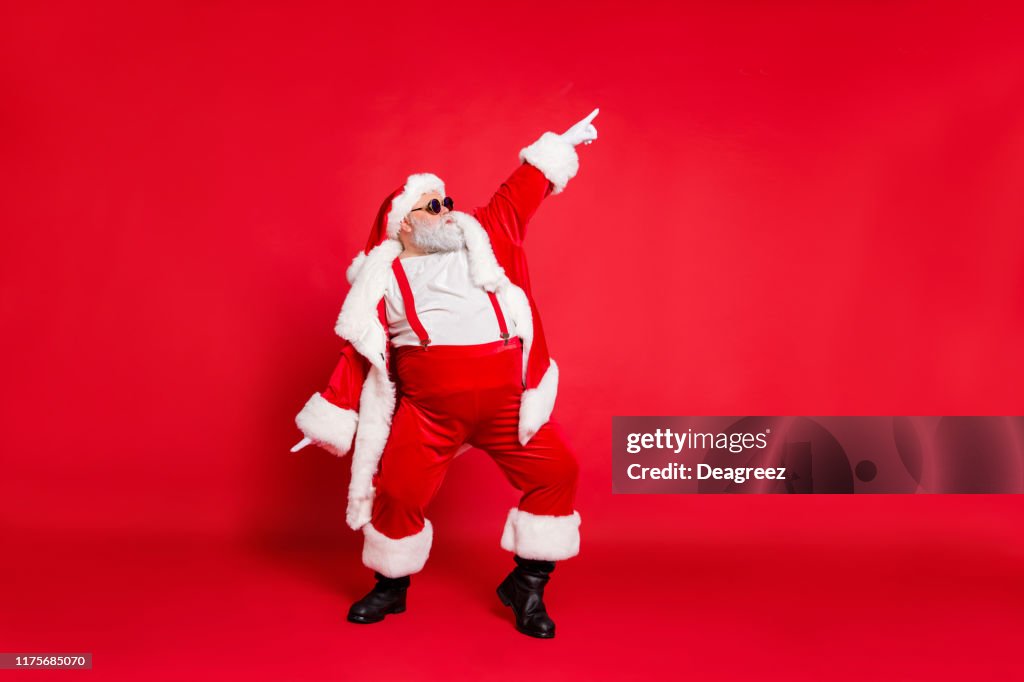 Full body photo of overweight carefree delightful ecstatic active energetic listening hip-hop music chic grandfather pointing finger up enjoying rhythm movement has big belly isolated vivid background