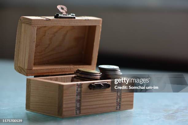 coins in a box/saving cencept - um único objeto fotografías e imágenes de stock