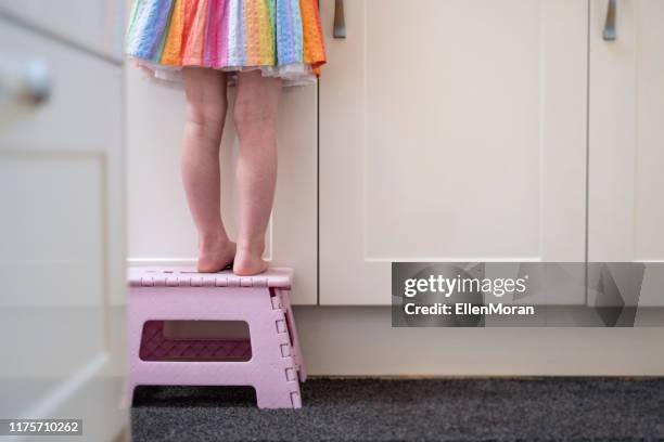 little girl on stool - kids feet in home stock pictures, royalty-free photos & images