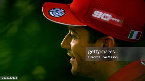 Charles Leclerc of Monaco and Ferrari talks to the media in the Paddock during previews ahead of the F1 Grand Prix of Singapore at Marina Bay Street...