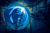 Welder man welding stainless steel tank
