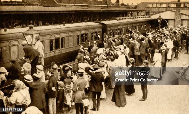 Crowds waving off troops leaving to fight in the First World, War, Britain . 'To the Front By Train and Boat': a train carrying troops from Hounslow...