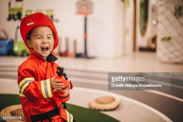 young boy in fireman costume - dressing up stock pictures, royalty-free photos & images