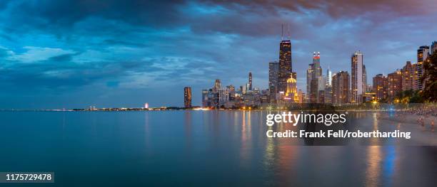 view of chicago skyline at dusk from north shore, chicago, illinois, united states of america, north america - bright chicago city lights stock-fotos und bilder