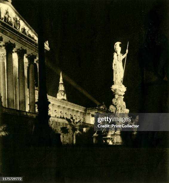 The Austrian Parliament Building by night, Vienna, Austria, circa 1935. View of the building floodlit at night. The Pallas Athene Fountain was...