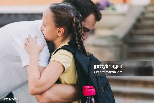 single parent family - first day school hug stock pictures, royalty-free photos & images
