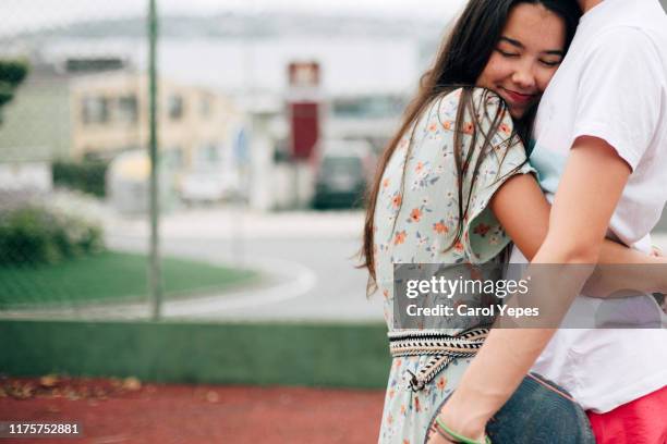 couple cuddling affectionate - casal adolescente imagens e fotografias de stock